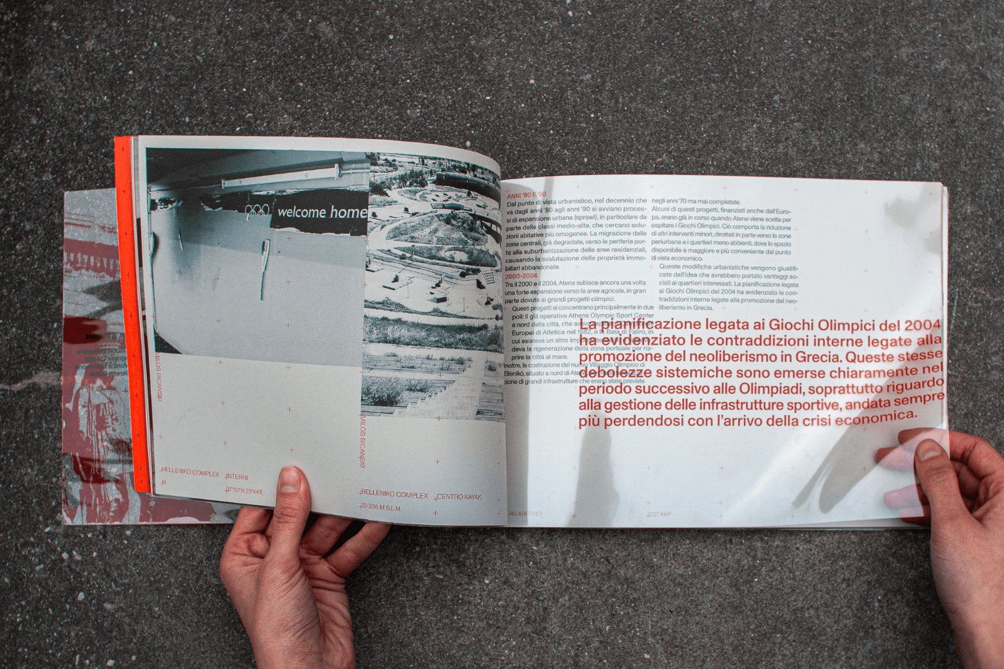 Hand leafing through the Anti-Atene book, a spread open with black-and-white photographs and red body text